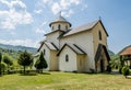 Monastery on the river Moraca amid mountains in the background.