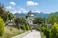 Monastery on the river Moraca amid mountains in the background Royalty Free Stock Photo