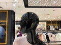 Portrait of black mannequin dummy head in fashion boutique showing new winter collection