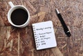 Monday meeting list text on note pad with background of cup of coffee and a pen Royalty Free Stock Photo