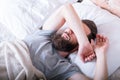 Monday morning laziness man bed covering eyes Royalty Free Stock Photo