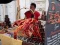 MONDONEDO, SPAIN - AUGUST 14, 2022: Dried smoked red peppers at the medieval fair counter in the old town Mondonedo,Lugo,Galicia,