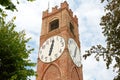 Belvedere ancient clock tower and trees in a summer day in Mondovi, Italy