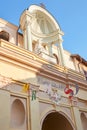 Mondovi, Funicular station entrance with beige facade and virgin Mary statue in a sunny summer day in Italy