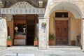 Ice cream shop cafe and old arcade with people in a sunny summer day in Mondovi, Italy