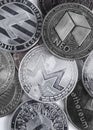 Monero coin on the background of coins of different cryptocurrencies close-up on a light background