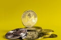 Monero coin dominates the background of multicolored coins of various cryptocurrencies on a light background