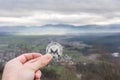 Monero silver coin, Hand hold Monero above the city