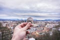 Monero silver coin, Hand hold Monero above the city