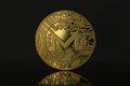 Monero XMR Crypto Coin placed on reflective surface in the dark background.