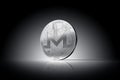 Monero XMR cryptocurrency physical concept coin on gently lit dark background.