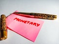 monetary finance banking related text displayed on pink paper with pen concept Royalty Free Stock Photo