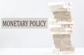 MONETARY POLICY text with wooden block stack on white background , business concept