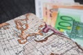 Money, Airplane ticket and map. Eurobanknotes with boarding pass and map, on black wooden background. Royalty Free Stock Photo