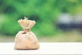 Money bag attached to the plaster on natural green background,Saving money for Medical expenses and Health care concept