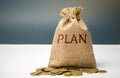 Money bag with coins and the word Plan. Personal financial planning concept. Management of the family budget. Savings and Royalty Free Stock Photo