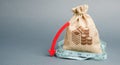 Money bag with red arrow down. The concept of reducing profits. Unprofitable business. Capital outflow. Report and financial Royalty Free Stock Photo