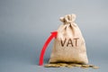 Money bag and red up arrow. The concept of increasing VAT tax. Tax burden on business consumers. VAT refund and double taxation Royalty Free Stock Photo