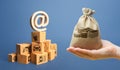 Money bag, stack of boxes and email internet symbol. Online Internet distribution of goods. E-commerce. Network marketing