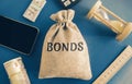 Money bag with the word Bonds. A bond is a security that indicates that the investor has provided a loan to the issuer. Equivalent