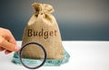 Money bag with the word Budget and tape measure. The concept of limited profit. Lack of money and poverty. Small income. Salary Royalty Free Stock Photo