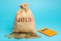 Money bag with the word 2019 and a calculator. Business Financial Reporting Concept. Evaluation of the financial position. Audit. Royalty Free Stock Photo