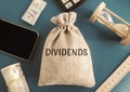 Money bag with the word Dividends. Payment made by a corporation to its shareholders as a distribution of profits. Concept