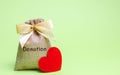 A money bag with the word Donation and a red heart. Accumulation of money for a medical donation. Health care. Saving. Social Royalty Free Stock Photo