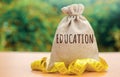 Money bag with the word Education. The concept of saving money for studies. Investments of budgetary funds in the educational