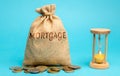 Money bag with the word Mortgage and hourglass. Mortgage rates concept. Loan and credit. Interest payment. Business and finance.