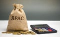 Money bag with the word SPAC - Special purpose acquisition company. Simplified listing of company, merger bypassing stock exchange