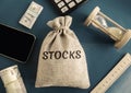 Money bag with the word Stocks. Trading on the stock exchange. Investment portfolio. Capital gains. Common and preferred stocks. Royalty Free Stock Photo