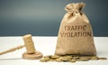 Money bag with the word Traffic violation and the judge`s hammer. Law. Court. Fine, legal fees. Traffic Tickets. Speeding. Failur Royalty Free Stock Photo