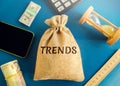 Money bag with the word Trends. Popular and relevant topics. New ideological trends. Recent and latest trend. Evaluation methods. Royalty Free Stock Photo