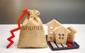 Money bag with the word Utilities and an up arrow and houses on a calculator. The concept of raising prices for the use of