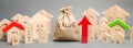 A money bag with the word Value, wooden houses and an up arrow. Concept of real estate market growth. High rental and mortgage Royalty Free Stock Photo