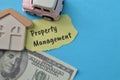 Money banknote, toy car and toy house with text PROPERTY MANAGEMENT Royalty Free Stock Photo