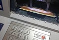 Money banknotes in ATM cash withdrawal machine