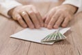 Money, banknotes in Polish currency Polish zloty lie on the table in an envelope. In the background, male hands hold the corner of Royalty Free Stock Photo