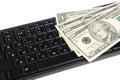 Money on black keyboard isolated on white Royalty Free Stock Photo