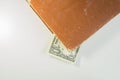 Money in a book. dollar bill used as a bookmark in the book on a white background