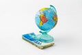 A money box made in the form of a globe, the planet Earth with a money slot at the top stands on a stack of Israeli banknotes of d Royalty Free Stock Photo