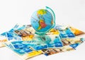 A money box made in the form of a globe, the planet Earth with a money slot at the top stands on a stack of Israeli banknotes of d Royalty Free Stock Photo