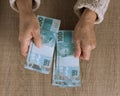 Money from Brazil. Above view of old retired person paying in ca Royalty Free Stock Photo