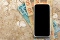 Money from Brazil. Blank cel phone screen and bills on marble Royalty Free Stock Photo