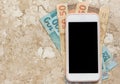 Money from Brazil. Blank cel phone screen and bills on marble Royalty Free Stock Photo