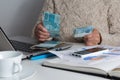 Money from Brazil. Woman holding bills on desk office