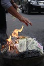 Money burning. US Dollars and Vietnam Dongs are burned up on the Royalty Free Stock Photo