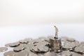 Money, Business, Finance, Retirement and Saving Concept. Close up of old businessman miniature figure standing on top of stack of