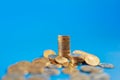 Money, Business and Risk Concept. Closeup of stack and pile of gold coins on blue background with copy space Royalty Free Stock Photo